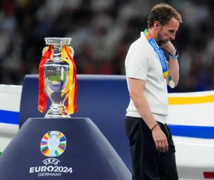 England's manager Gareth Southgate walks past the trophy at the end of the match. England, the birthplace of football, is still without a major title in the men's game since winning the 1966 World Cup. [Manu Fernandez/AP Photo]